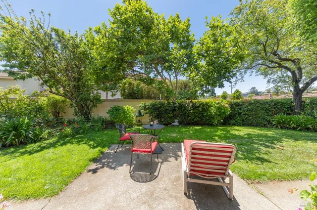 a backyard of a house with outdoor seating