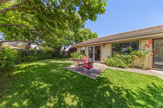 a view of a house with backyard porch and sitting area