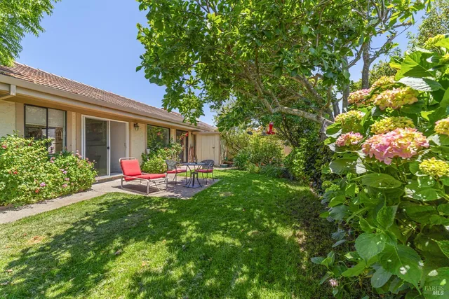 a front view of a house with yard and green space