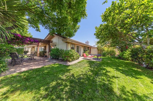 a front view of a house with yard and sitting area