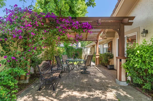 a view of a chairs and table in backyard of the house