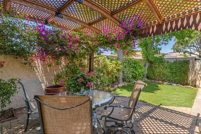 a view of a patio with table and chairs and potted plants