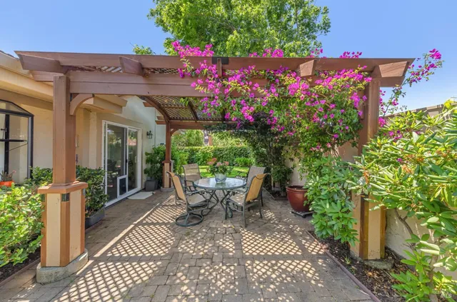 a view of an outdoor sitting area with a tree