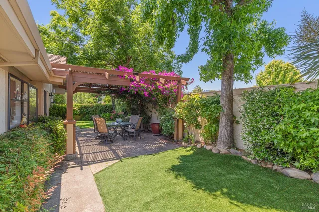 a view of yard with green space and seating area