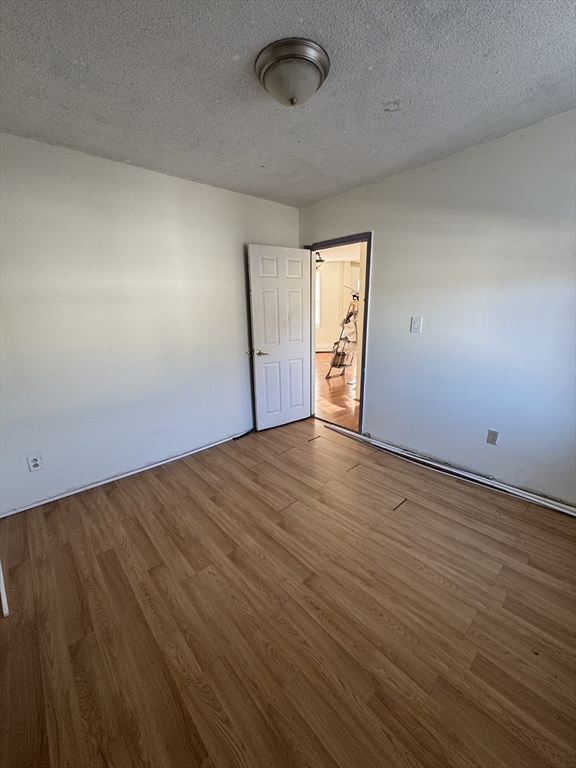 98 Lafayette Park, Unit 2 Lynn, MA 01902 - Photo 11 of 18 an empty room with wooden floor and windows