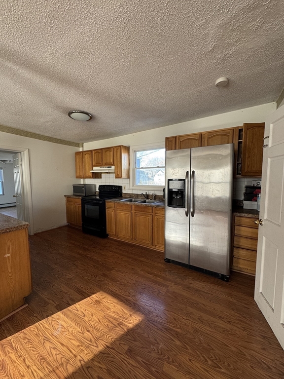 98 Lafayette Park, Unit 2 Lynn, MA 01902 - Photo 2 of 18 a kitchen with granite countertop stainless steel appliances and a refrigerator