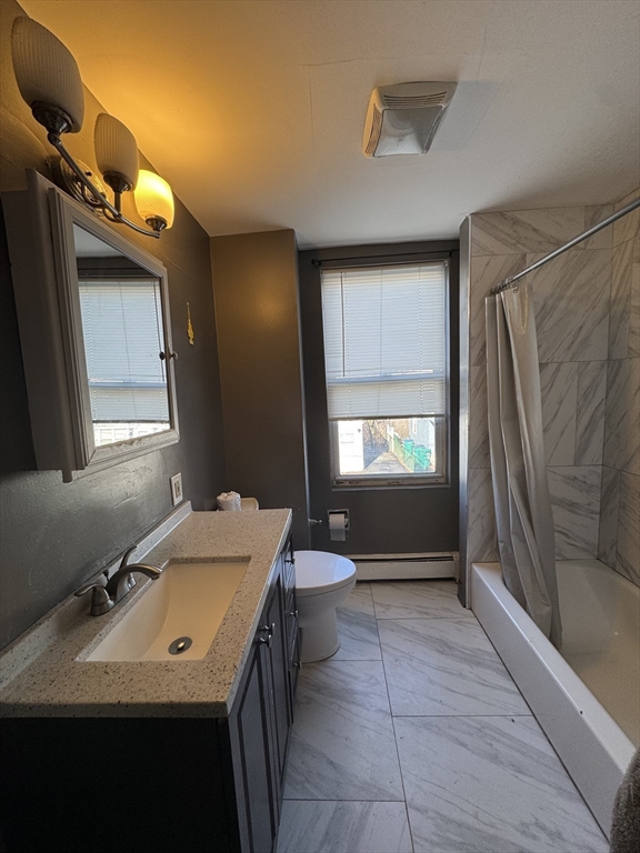 98 Lafayette Park, Unit 2 Lynn, MA 01902 - Photo 5 of 18 a bathroom with a sink a toilet and mirror