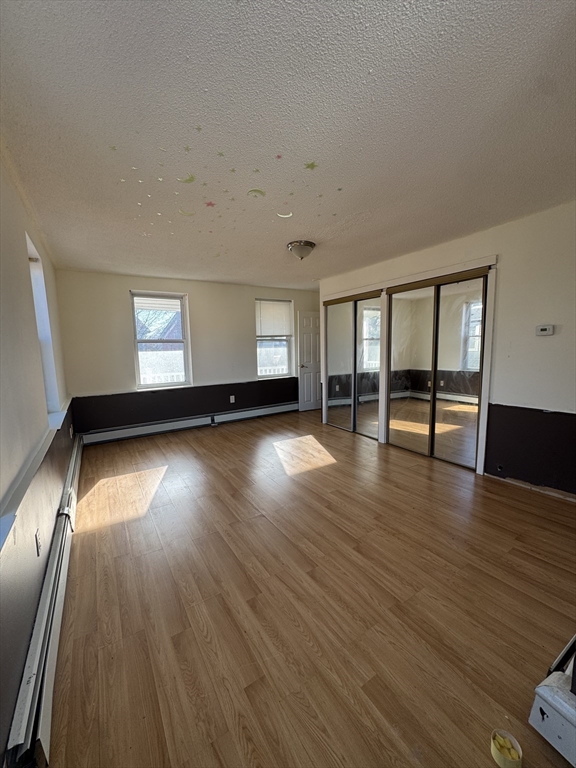 98 Lafayette Park, Unit 2 Lynn, MA 01902 - Photo 9 of 18 wooden floor in an empty room with a window