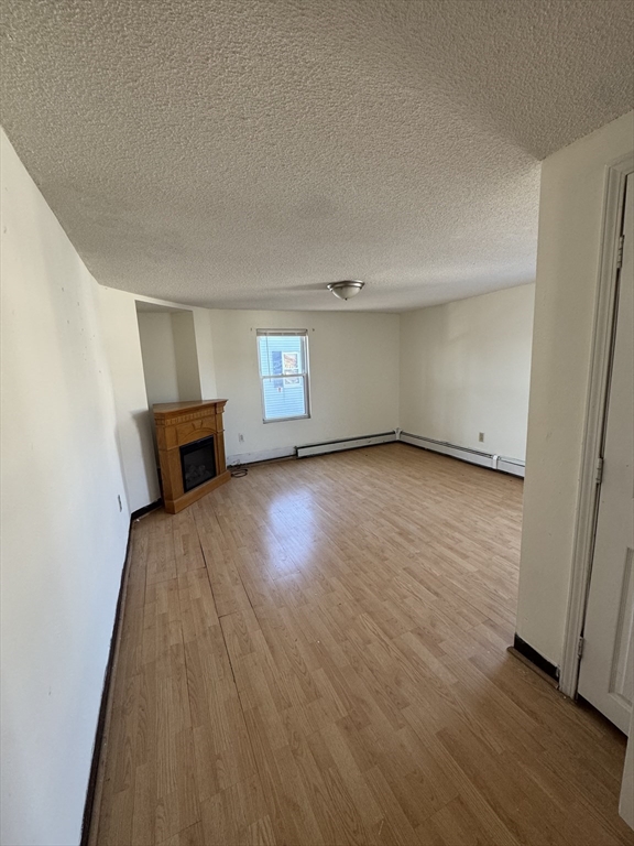 98 Lafayette Park, Unit 2 Lynn, MA 01902 - Photo 10 of 18 a view of empty room with wooden floor and fan