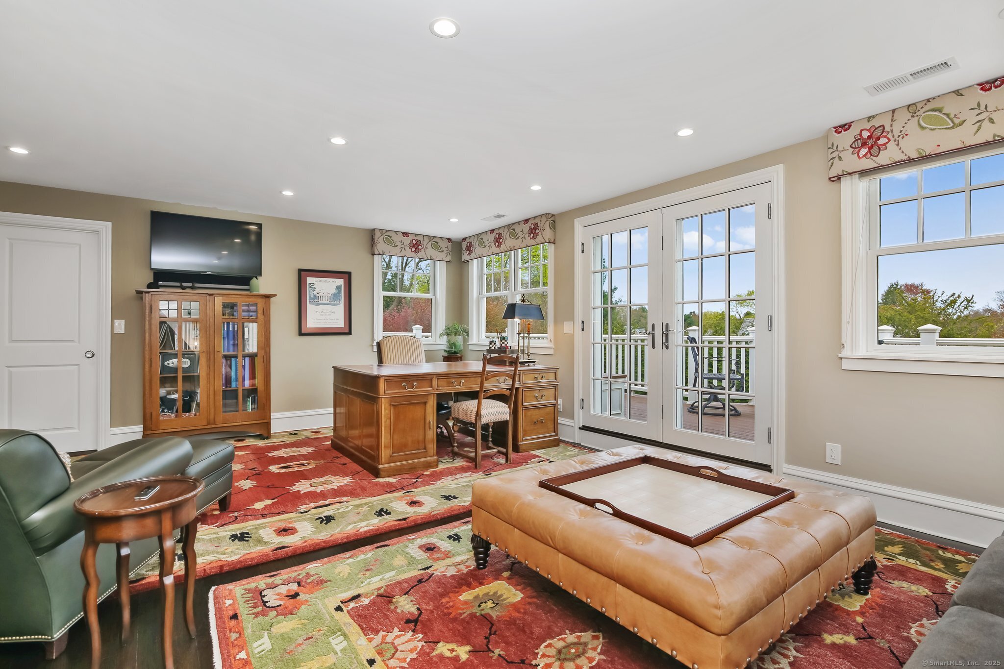 11 Old Hill Road Westport, CT 06880 - Photo 24 of 34 a living room with furniture a flat screen tv and a floor to ceiling window