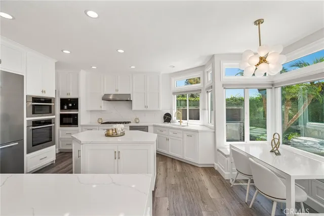 a bathroom with a granite countertop sink and a large window