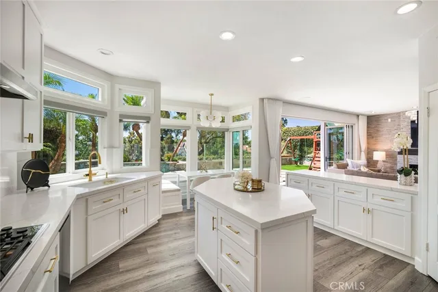 a dining room with wooden floor and large windows