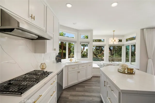 a kitchen with refrigerator cabinets and wooden floor