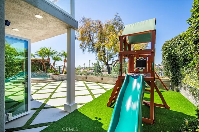 a view of a chair and fire pit with flower plants