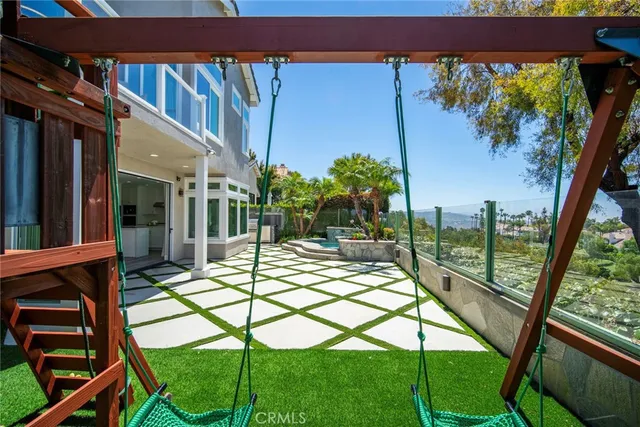 a view of a house with backyard porch and sitting area