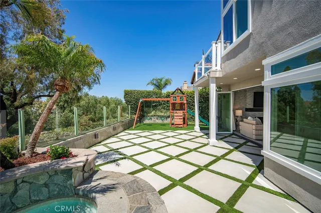 a living room with large window and a flat screen tv