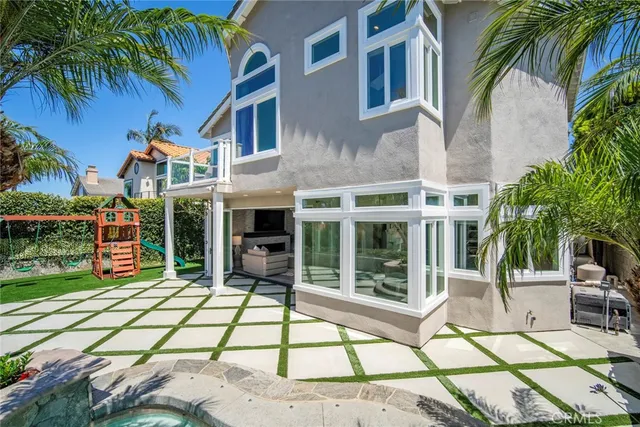 a spacious bedroom with a bed and a chandelier