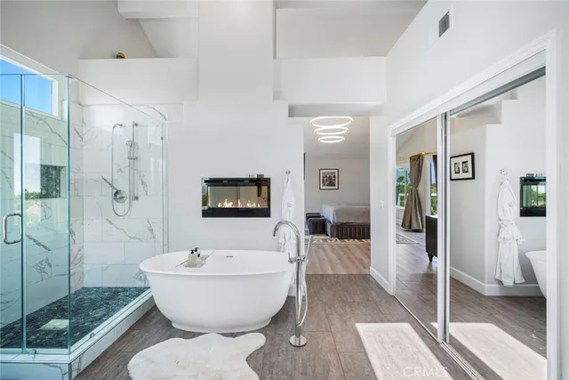 a view of a livingroom with furniture flat screen tv and windows