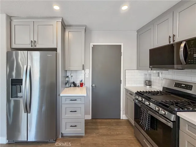 a kitchen with stainless steel appliances and refrigerator