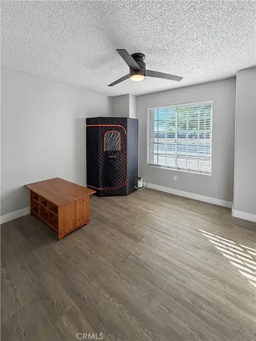 a spacious bedroom with a bed and a window