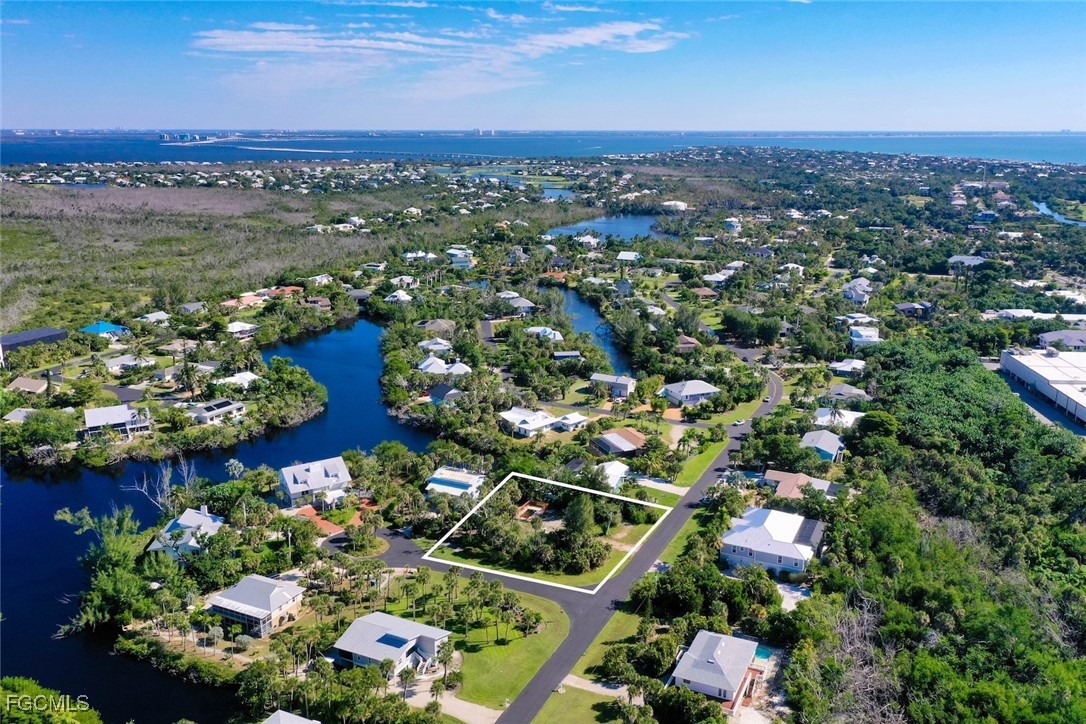 1653 Bunting Lane Sanibel, FL 33957 - Photo 6 of 12 an aerial view of lake and residential houses with outdoor space