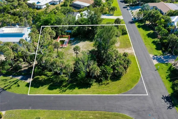 an aerial view of a residential houses with yard