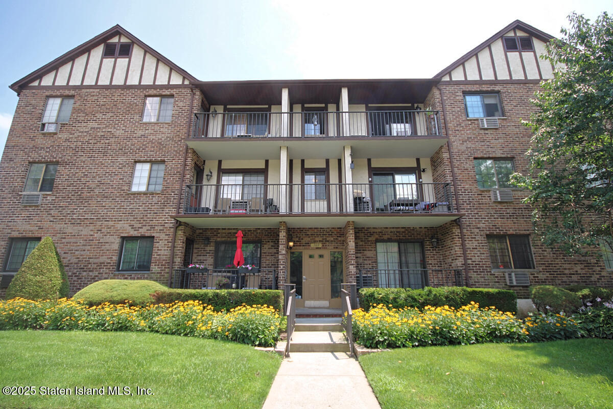 160 Devon Loop, Unit 5 Staten Island, NY 10314 - Photo 1 of 20 a front view of a house with a yard and plants