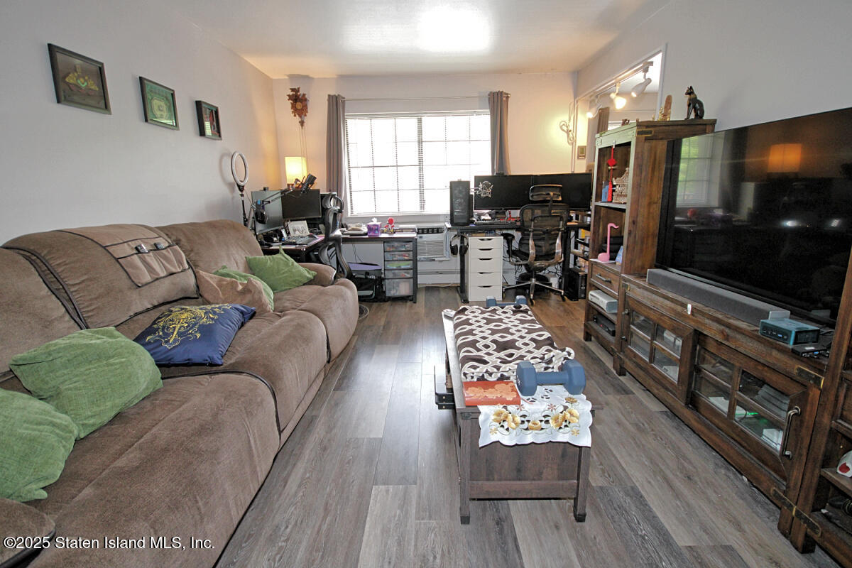 160 Devon Loop, Unit 5 Staten Island, NY 10314 - Photo 3 of 20 a living room with furniture and a flat screen tv