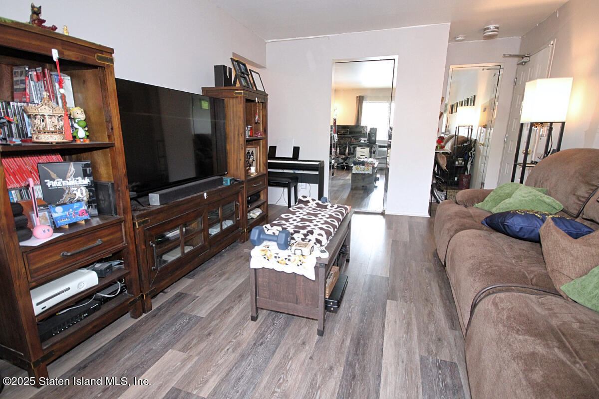 160 Devon Loop, Unit 5 Staten Island, NY 10314 - Photo 5 of 20 a living room with furniture and a flat screen tv