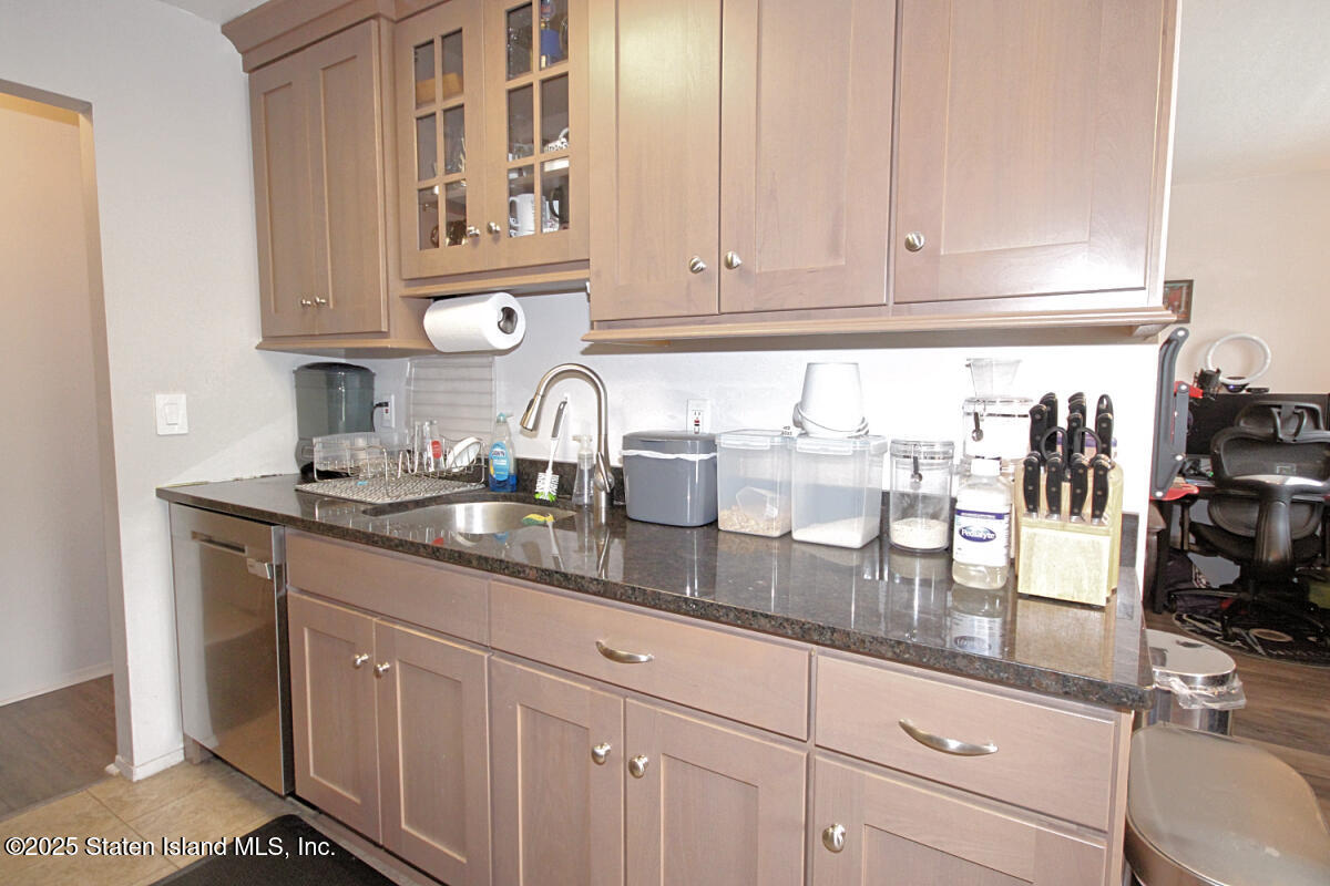 160 Devon Loop, Unit 5 Staten Island, NY 10314 - Photo 9 of 20 a kitchen with stainless steel appliances granite countertop a sink and cabinets