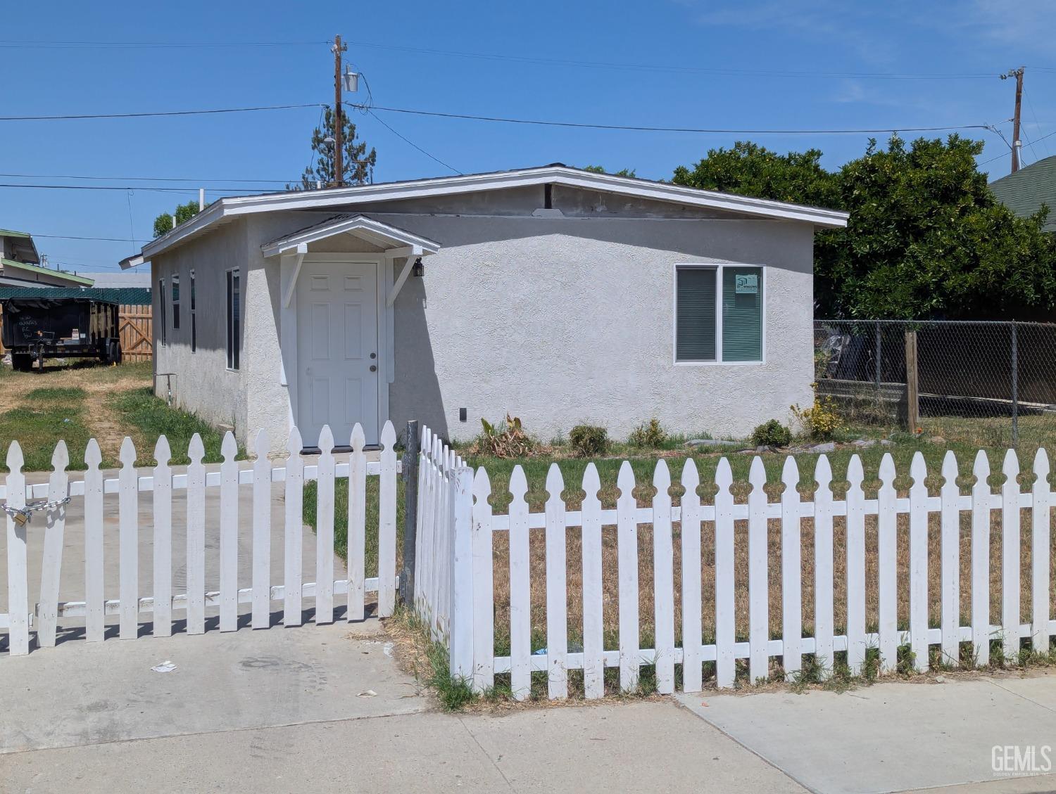 a front view of a house with wooden fence