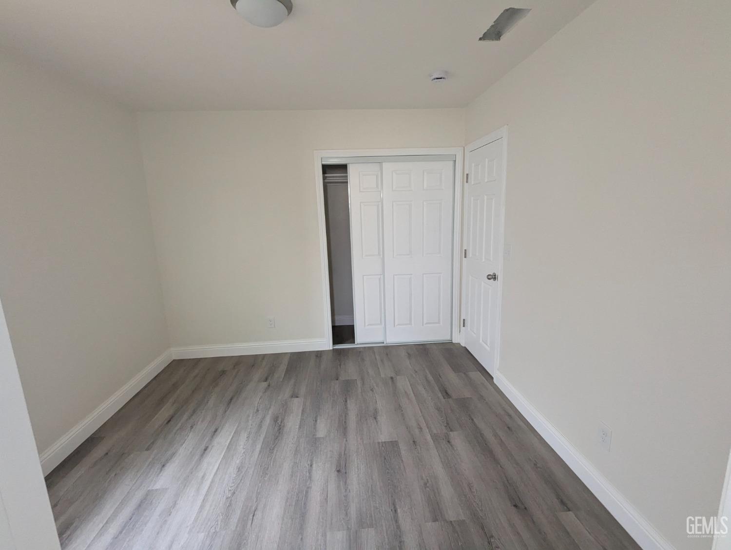 Undisclosed Address Bakersfield, CA 93307 - Photo 12 of 17 a view of an empty room with wooden floor