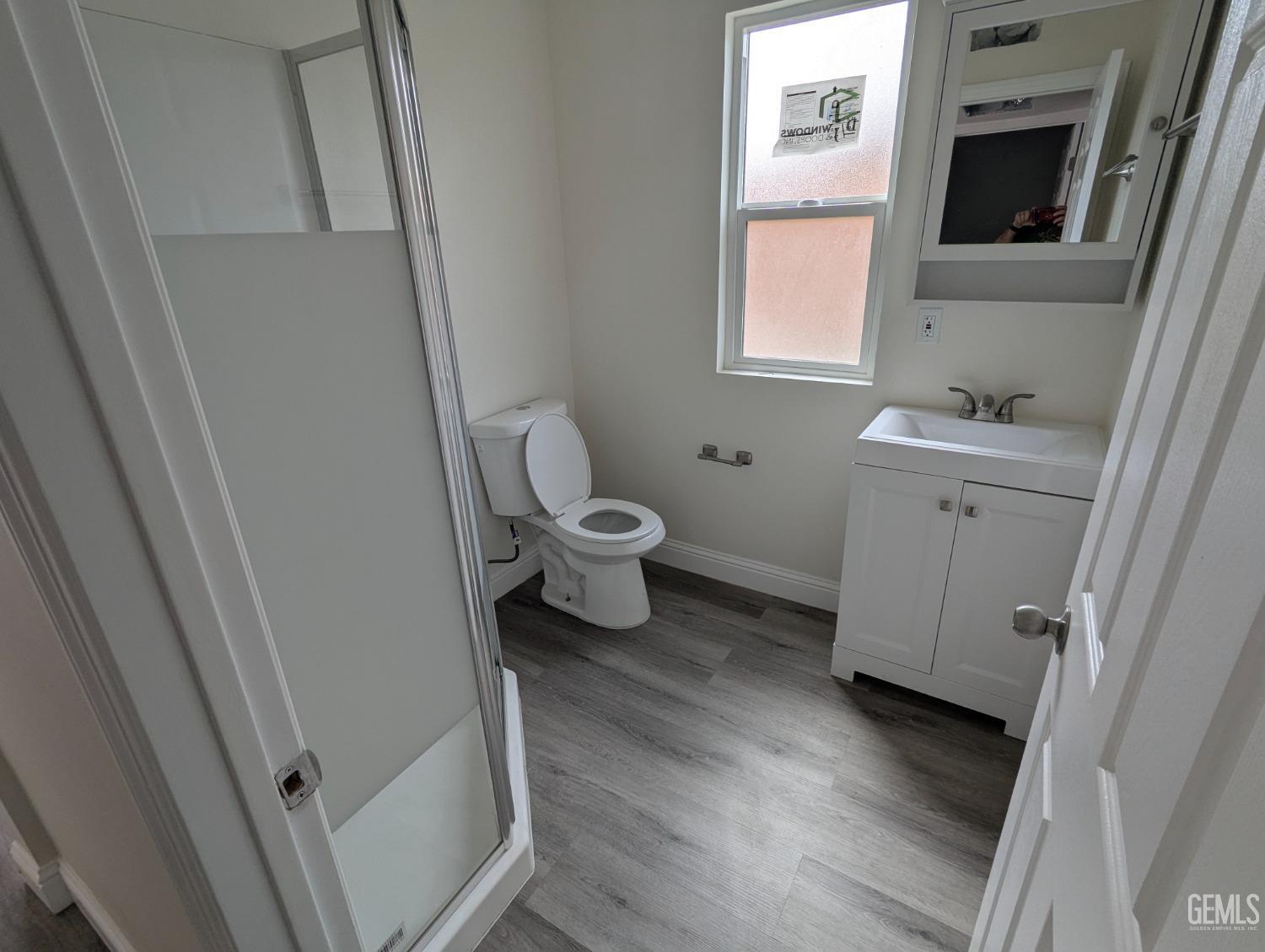Undisclosed Address Bakersfield, CA 93307 - Photo 15 of 17 a bathroom with a toilet sink and a mirror