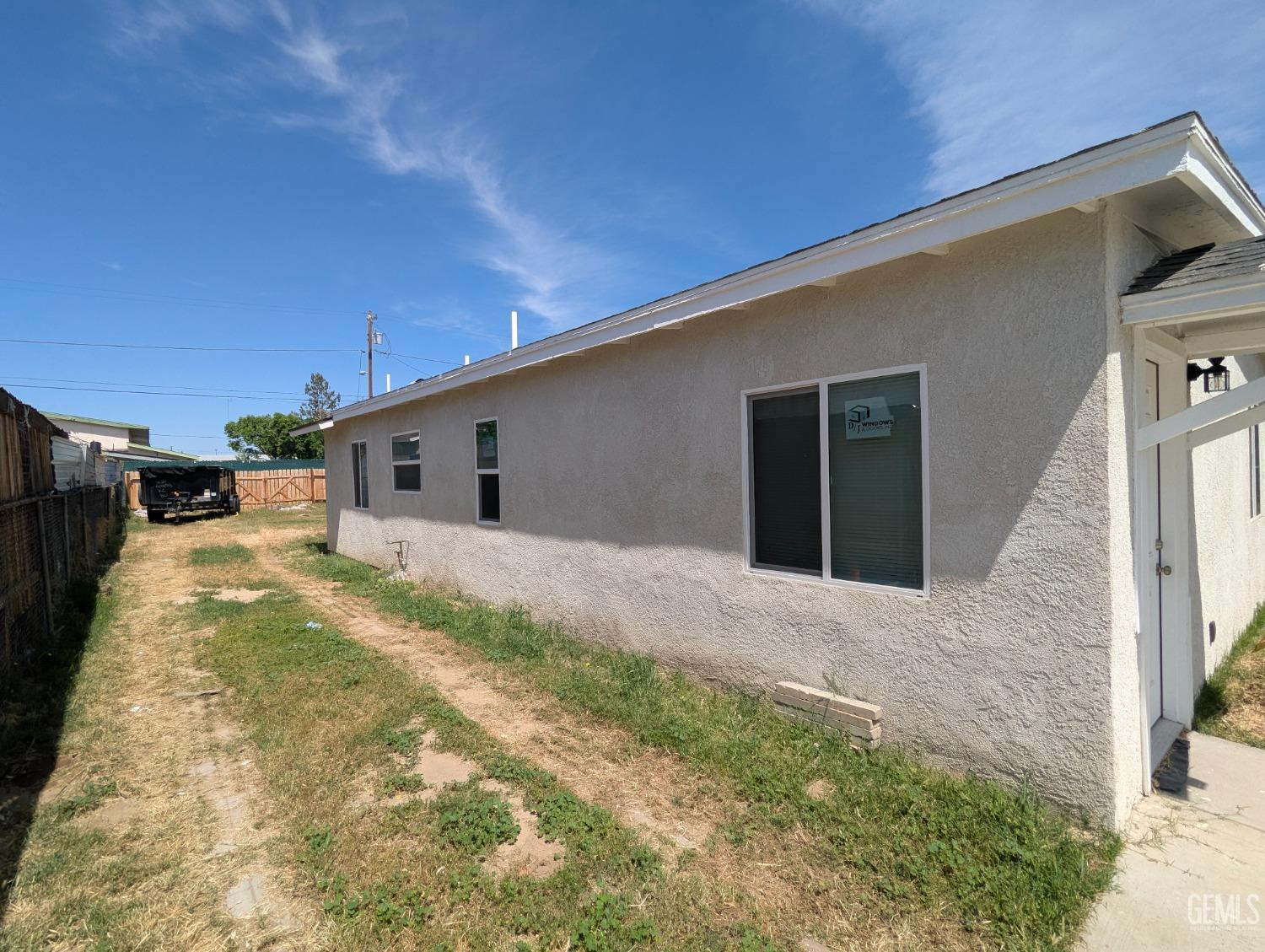 Undisclosed Address Bakersfield, CA 93307 - Photo 2 of 17 a house with yard in front of it