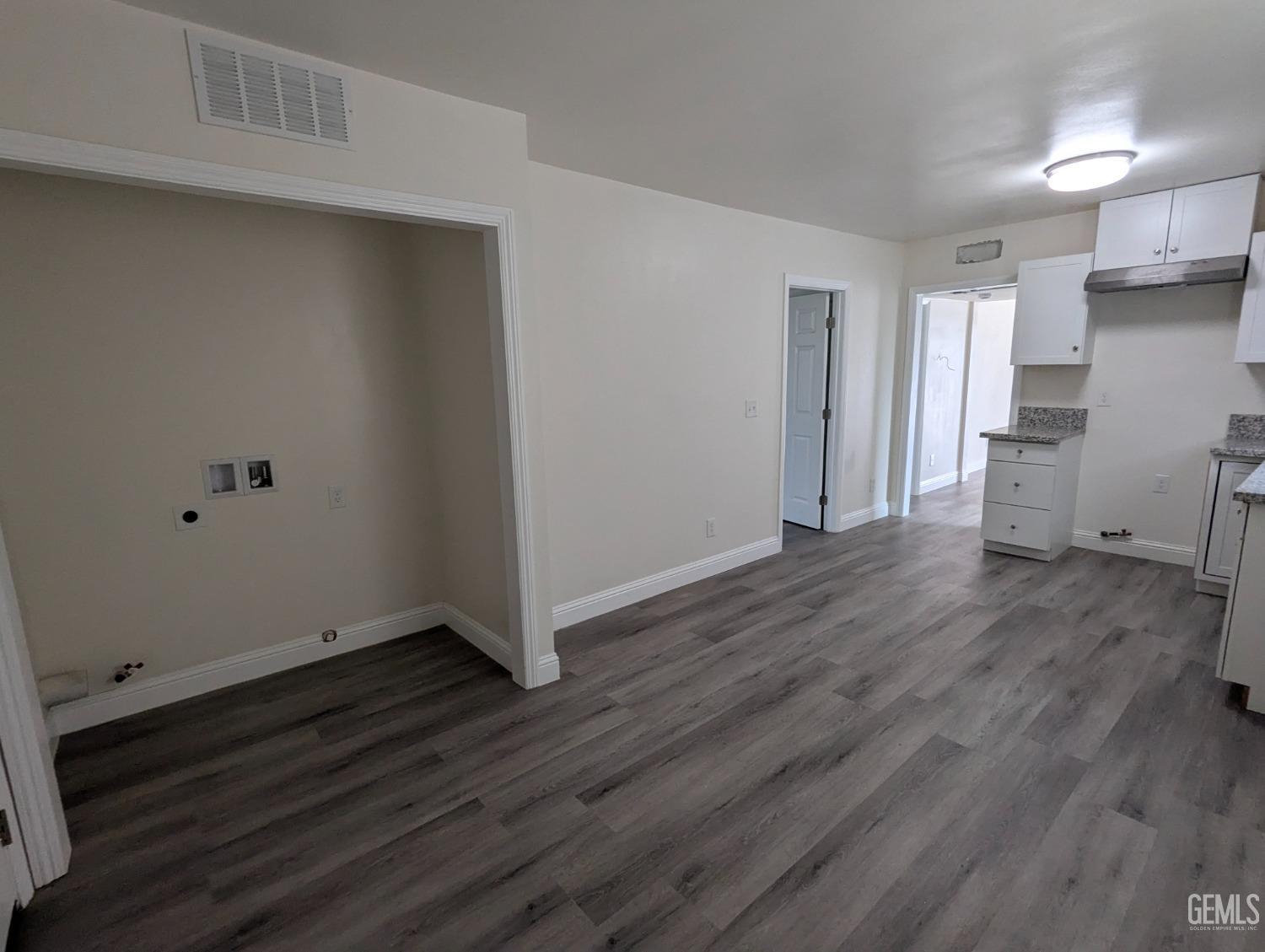 Undisclosed Address Bakersfield, CA 93307 - Photo 10 of 17 a view of an empty room with wooden floor and a window