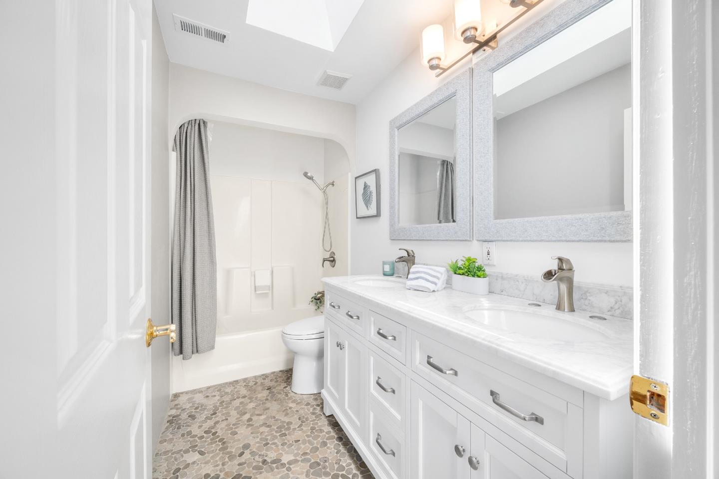 105 Wesley Street Capitola, CA 95010 - Photo 26 of 55 a bathroom with a double vanity sink a toilet and a mirror