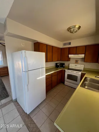 a kitchen with stainless steel appliances granite countertop a refrigerator sink and cabinets