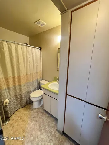 a bathroom with a toilet and a shower