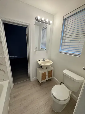 a bathroom with a bathtub and a toilet