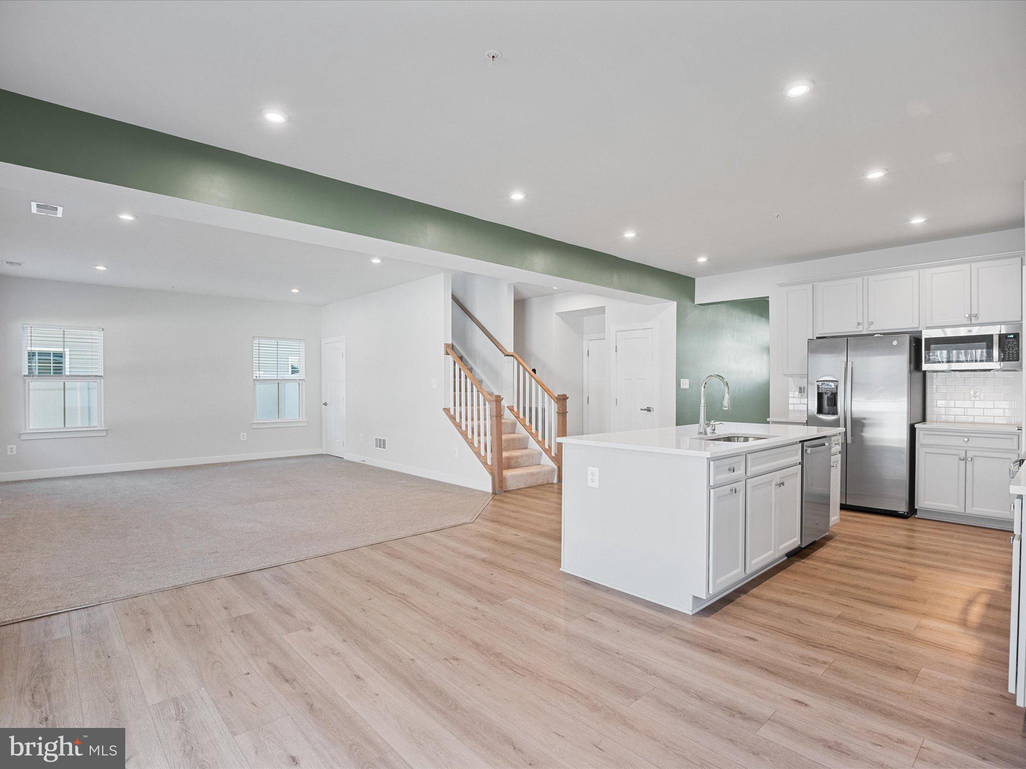 303 Pathfinder Circle Grasonville, MD 21638 - Photo 16 of 38 a large white kitchen with a large counter top appliances and cabinets