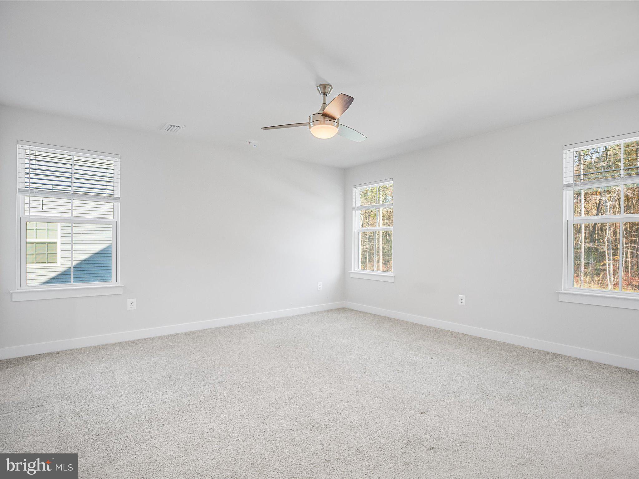 303 Pathfinder Circle Grasonville, MD 21638 - Photo 28 of 38 an empty room with a window and ceiling fan