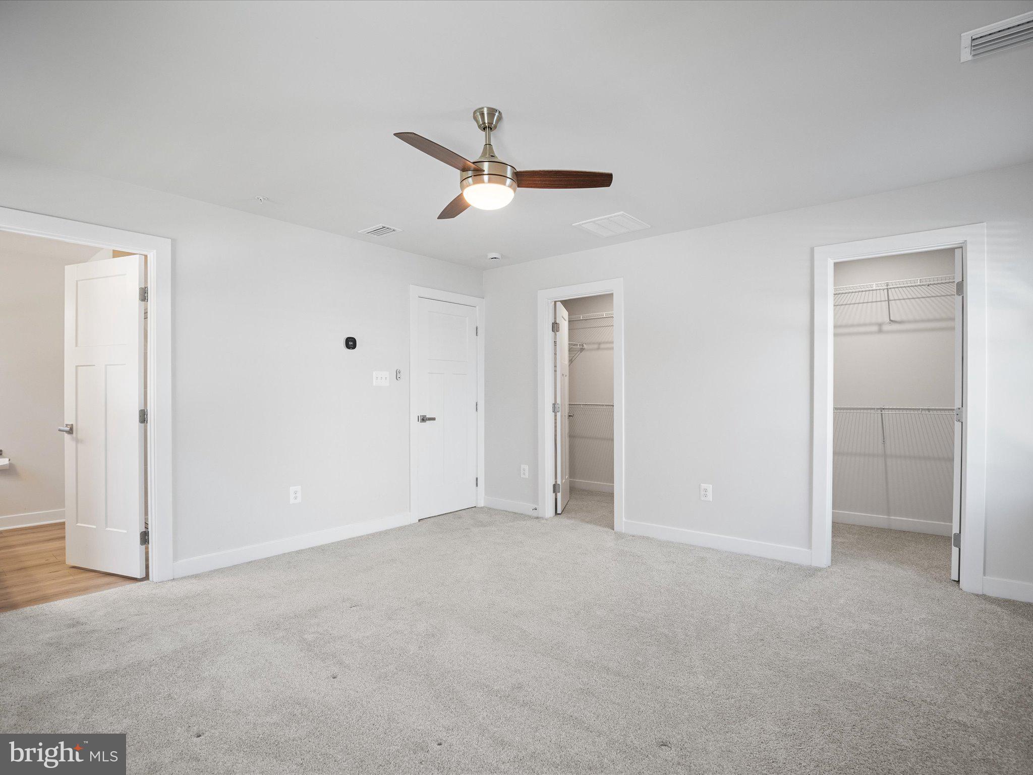 303 Pathfinder Circle Grasonville, MD 21638 - Photo 29 of 38 a view of an empty room with a ceiling fan