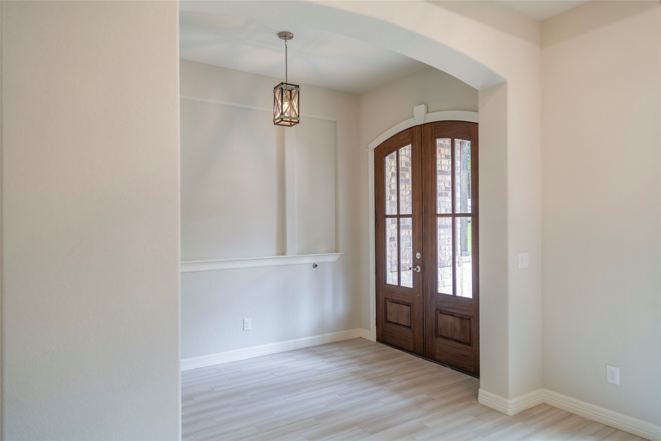 42 Sawgrass Trinity, TX 75862 - Photo 2 of 42 an empty room with wooden floor and windows