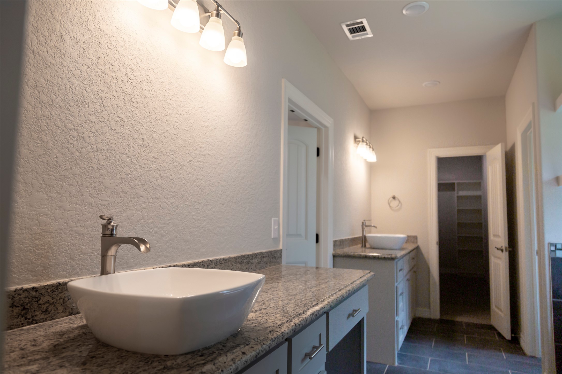 42 Sawgrass Trinity, TX 75862 - Photo 22 of 42 a spacious bathroom with a granite countertop sink and a mirror