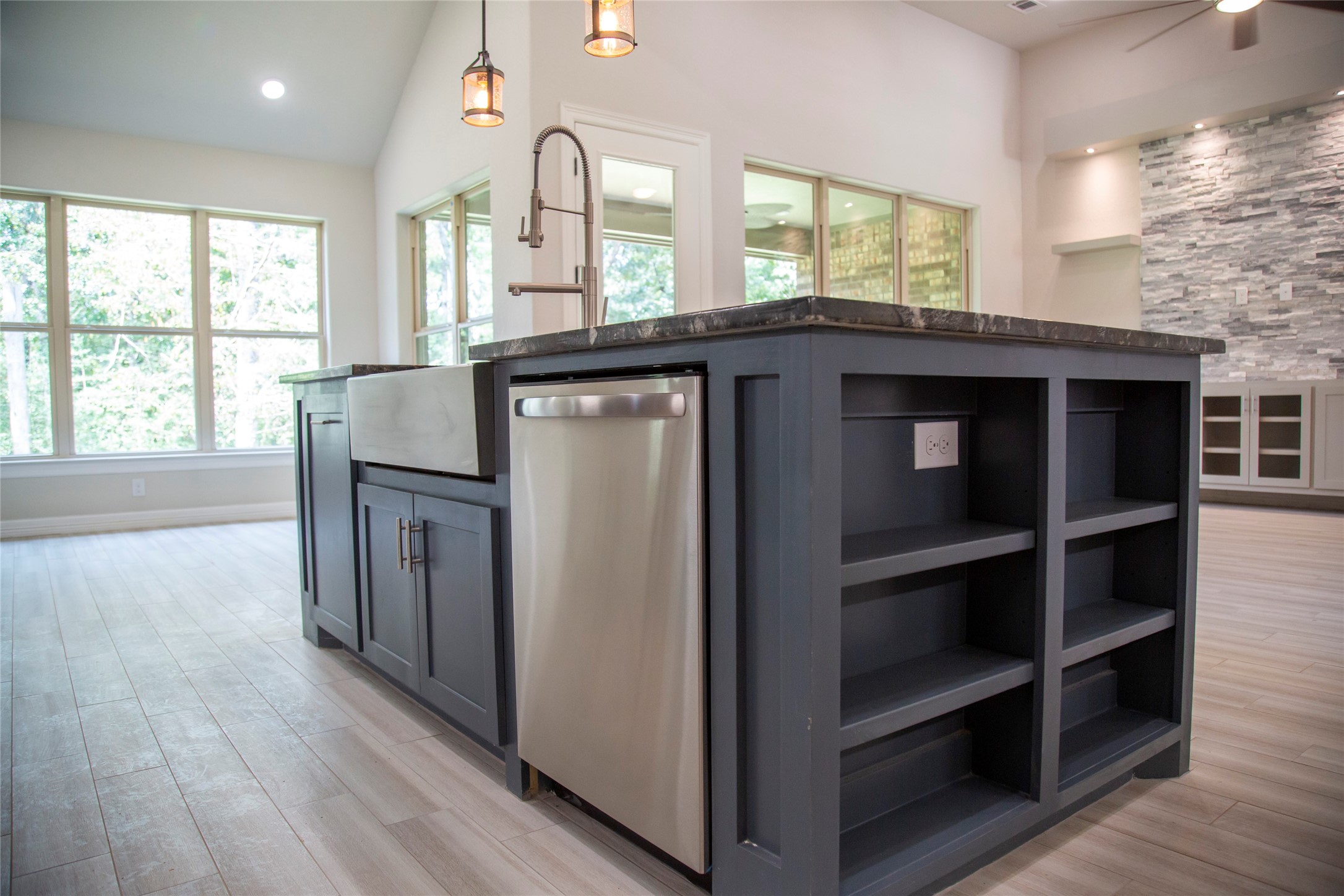 42 Sawgrass Trinity, TX 75862 - Photo 7 of 42 a kitchen with kitchen island a sink wooden floor and a large window