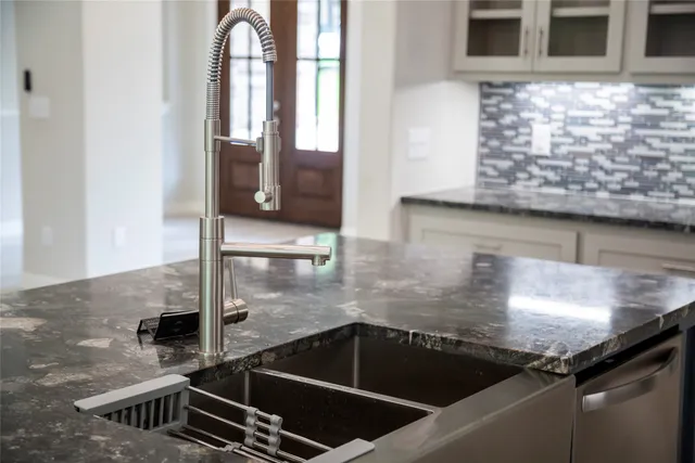 a kitchen with a sink a counter and appliances