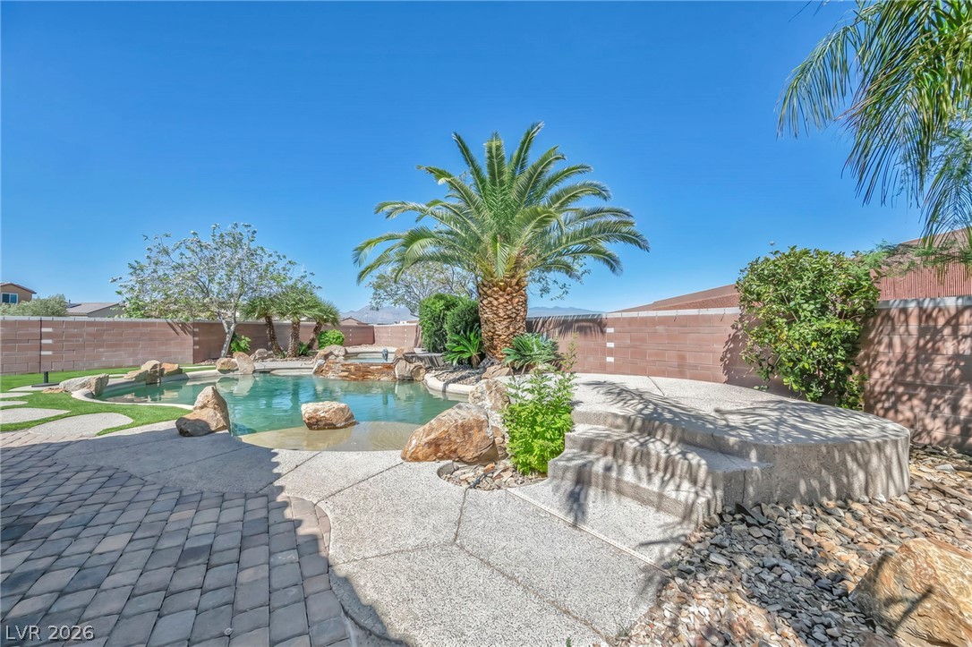 6405 North Raptor Court North Las Vegas, NV 89084 - Photo 45 of 66 An oasis of tranquility awaits with this pool, complete with rock features and surrounded by tropical landscaping.