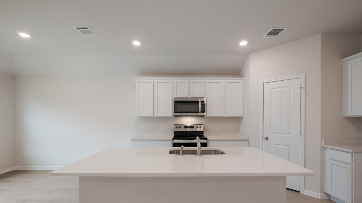 329 Lone Cedar Road Marble Falls, TX 78654 - Photo 11 of 19 a kitchen with a sink a stove and cabinets