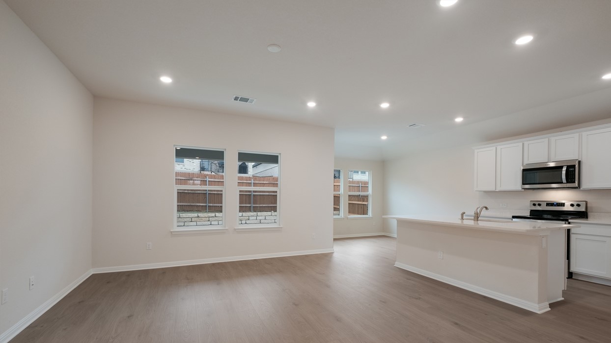 329 Lone Cedar Road Marble Falls, TX 78654 - Photo 5 of 19 a kitchen with stainless steel appliances a stove top oven a sink a refrigerator and a window