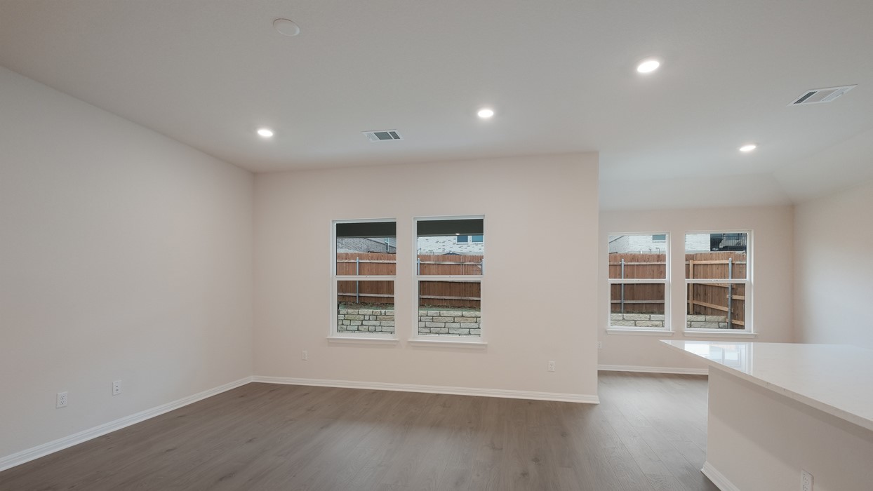 329 Lone Cedar Road Marble Falls, TX 78654 - Photo 7 of 19 an empty room with wooden floor and windows